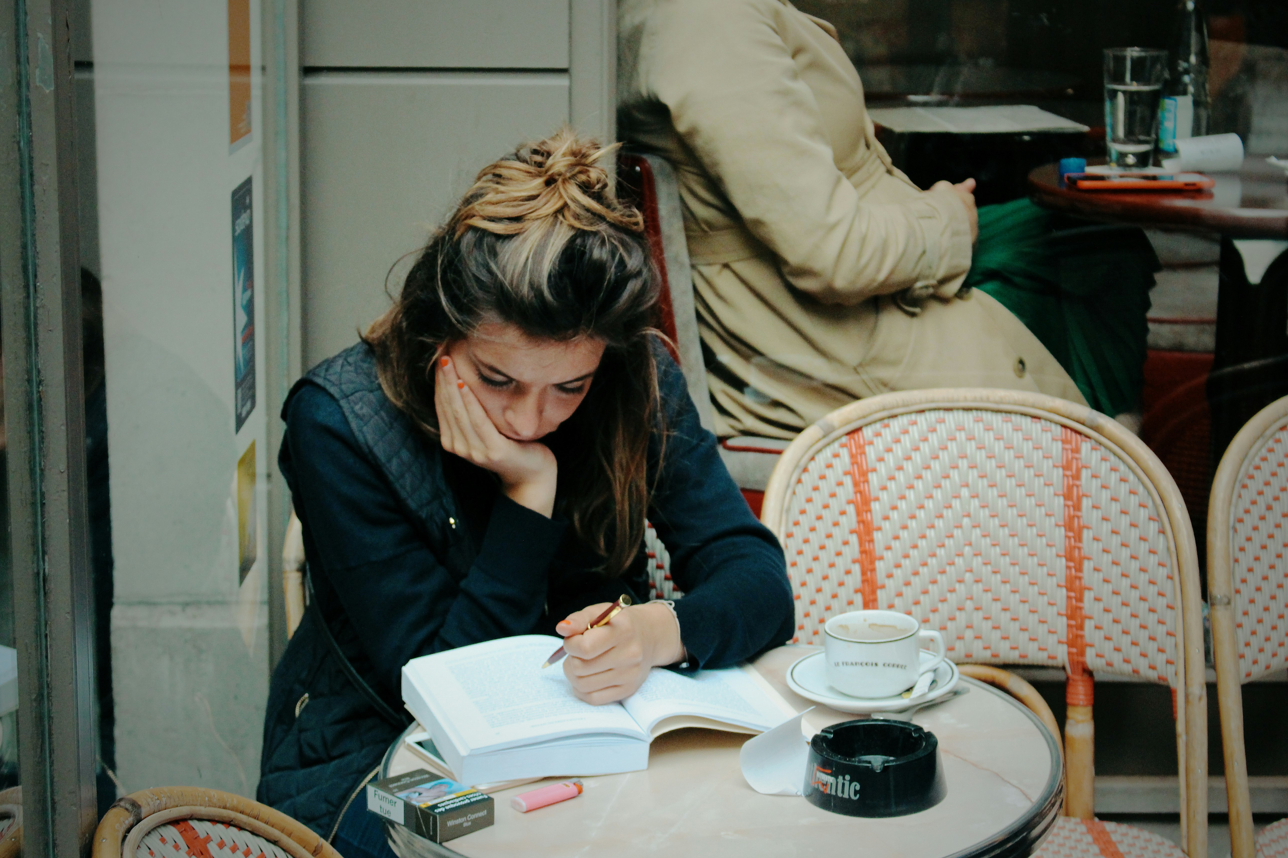 woman in black jacket sitting on chair